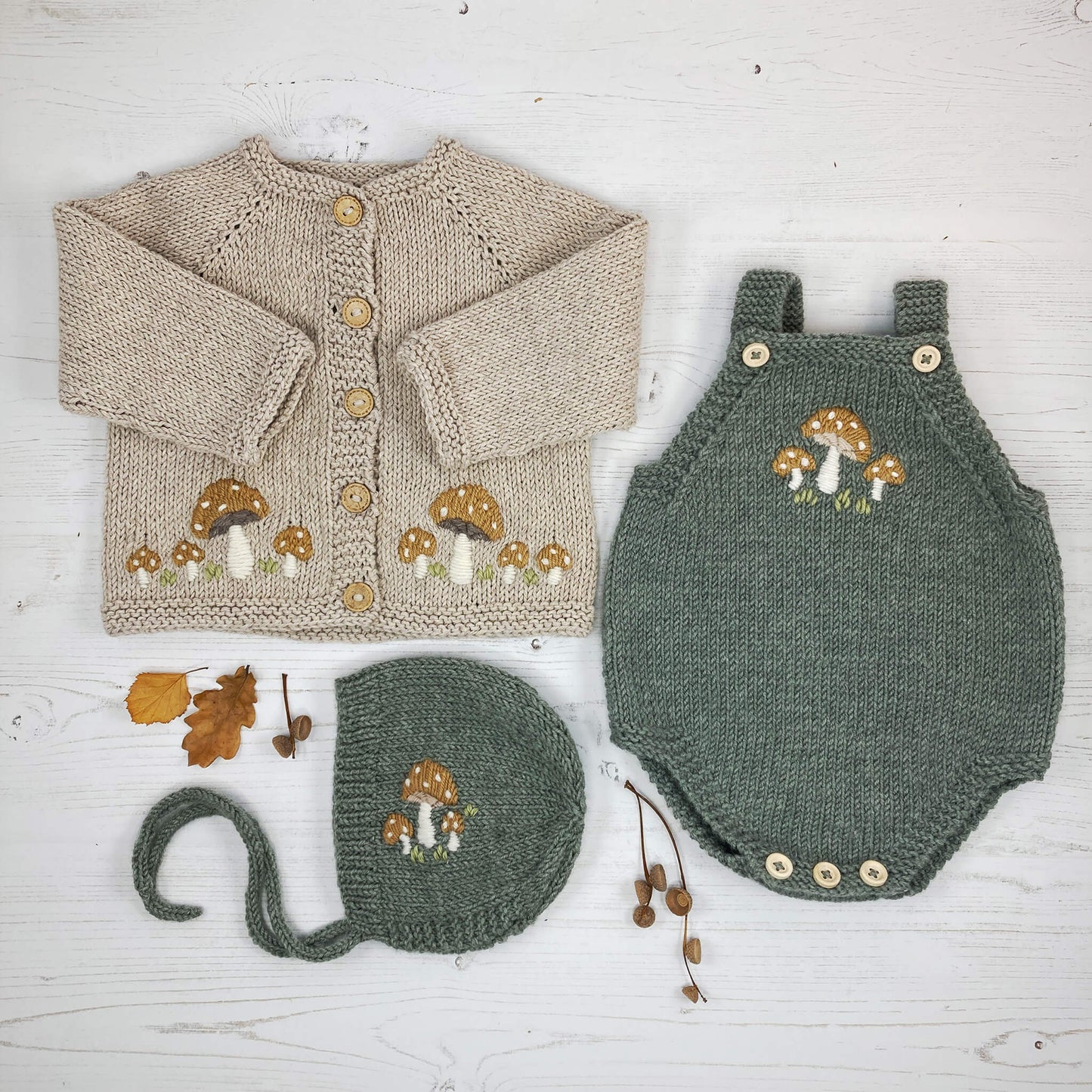 a set of three baby knitting patterns with toadstool embroidery