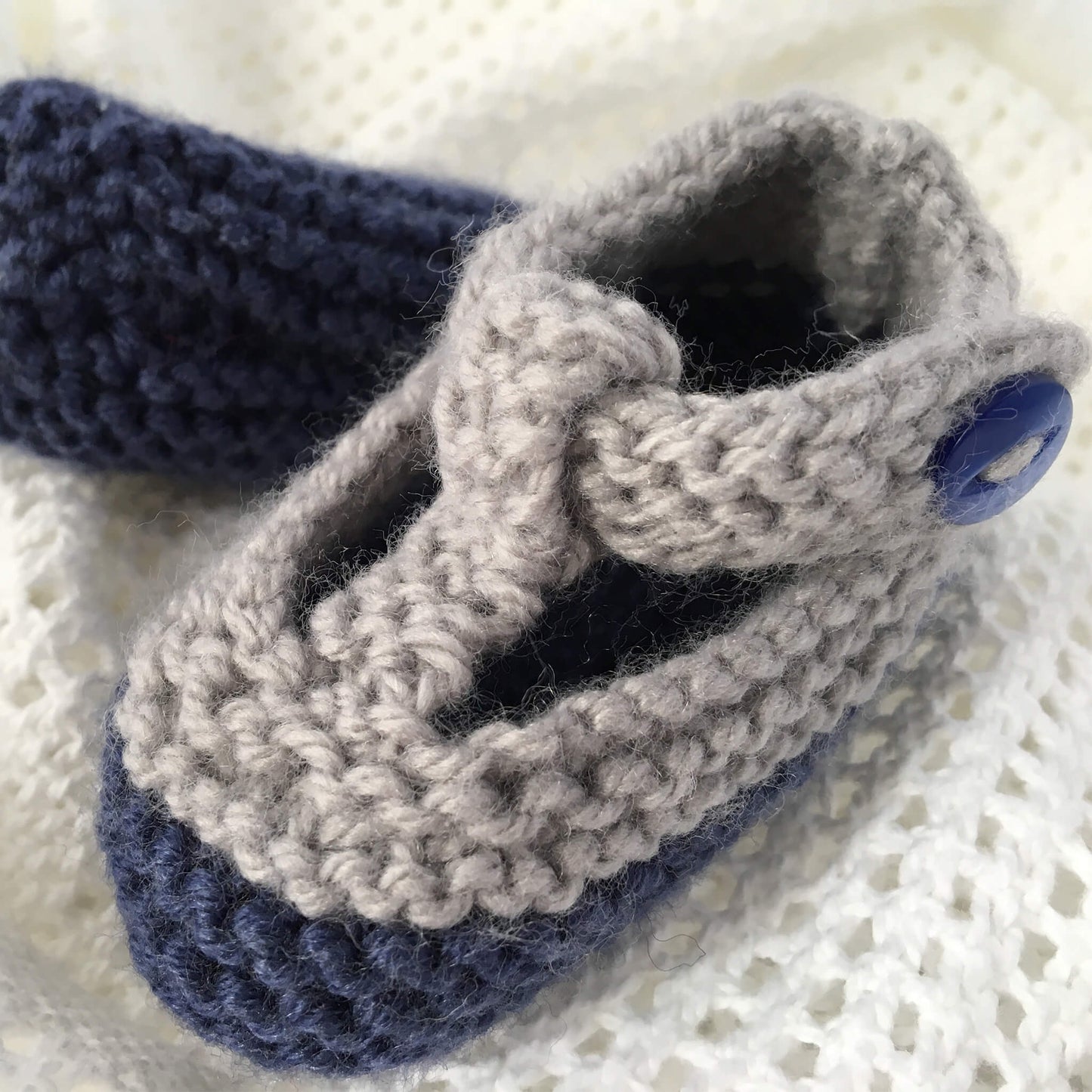 a close up view of a classic baby shoes knitting pattern