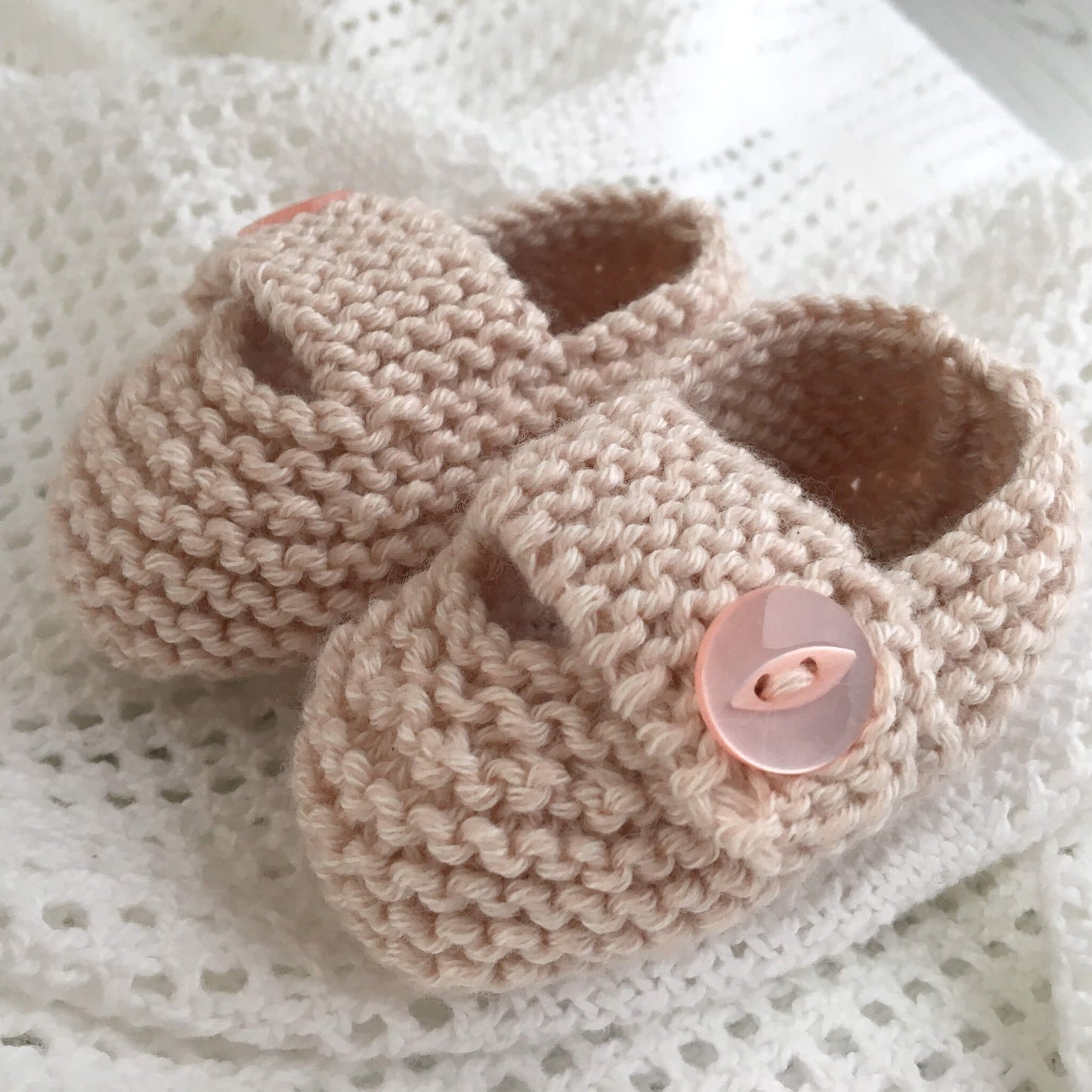 an easy knitting pattern for baby shoes. samples are shown in a pale dusty pink
