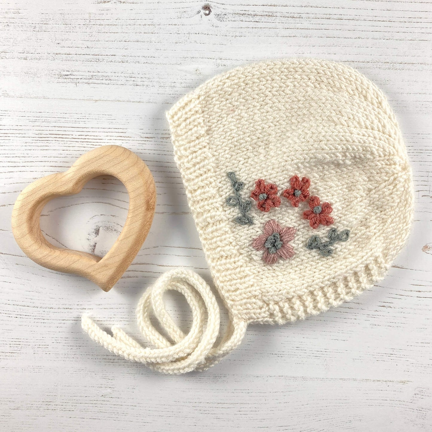 knitting pattern for baby bonnet with floral embroidery