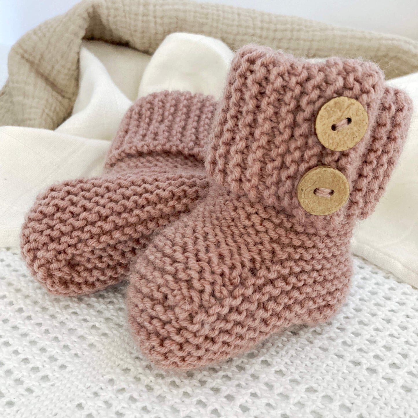 a baby booties knitting pattern with turn down garter stitch cuff and faux button opening