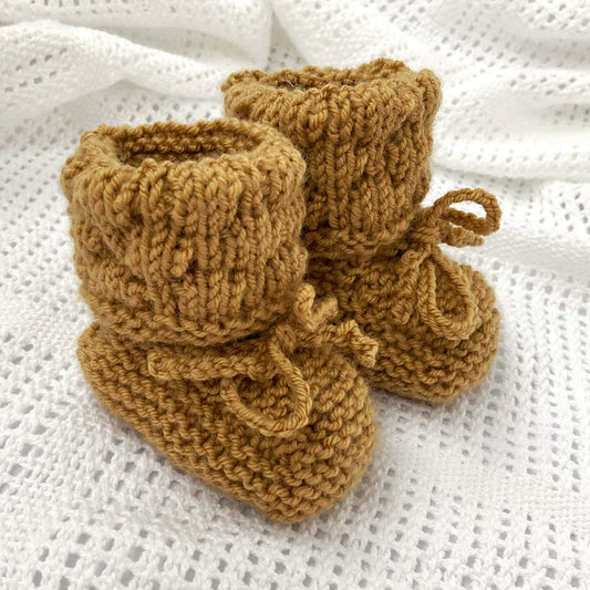 bubble stitch booties knit pattern shown in mustard colour yarn