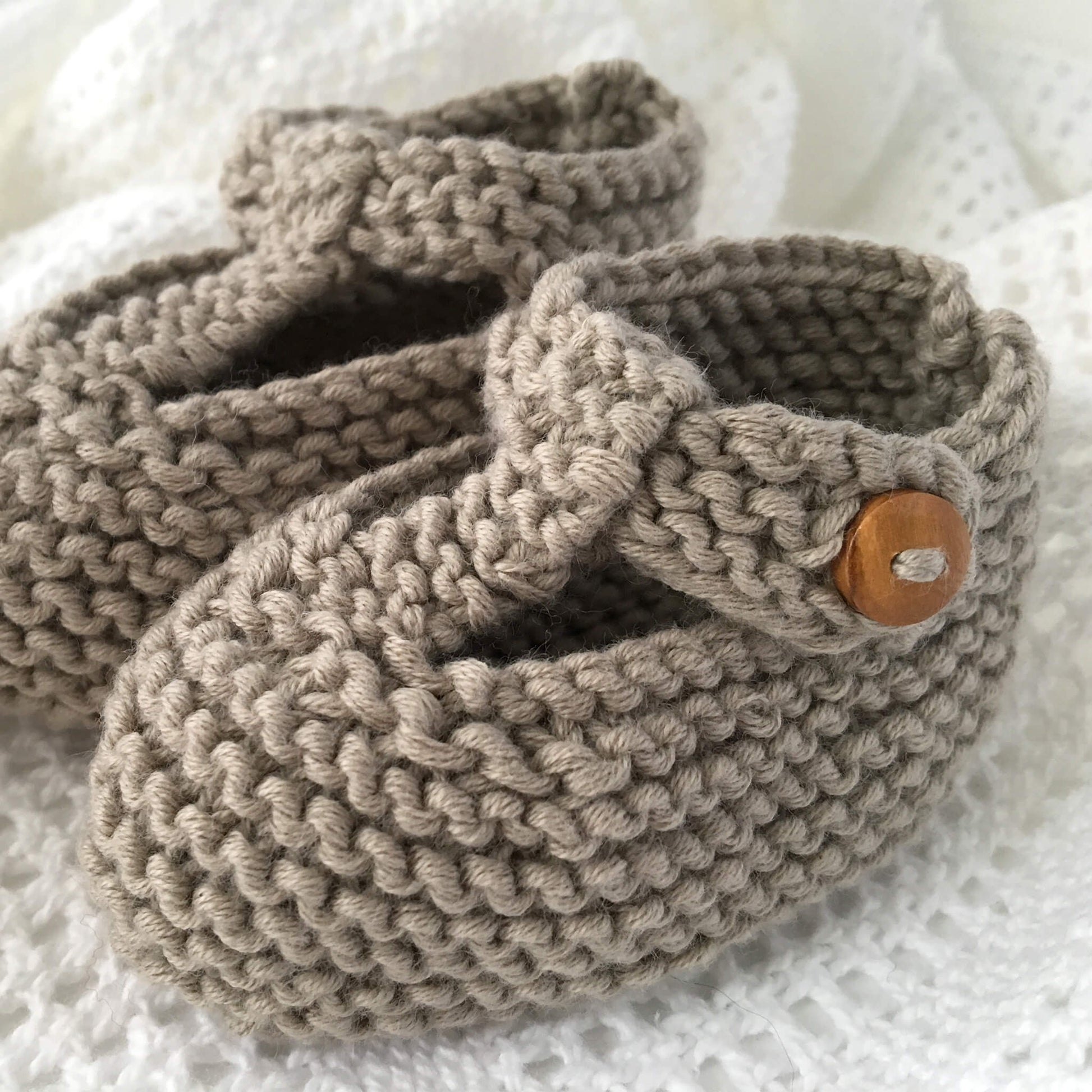 a knitting pattern for button fastening baby shoes