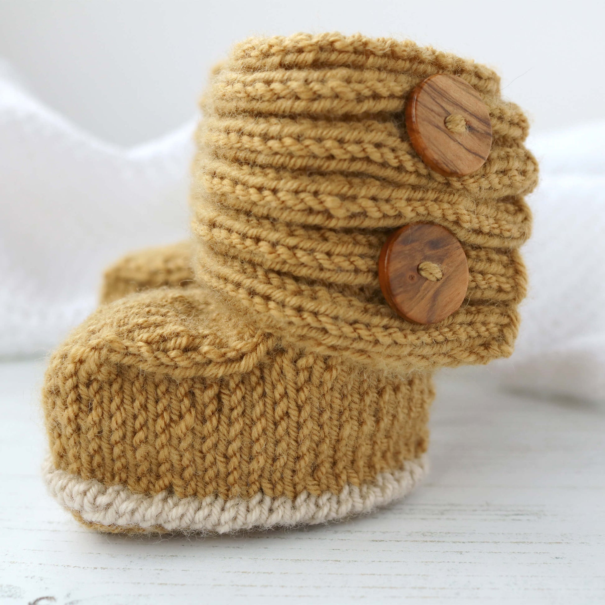 button opening baby booties knitting pattern