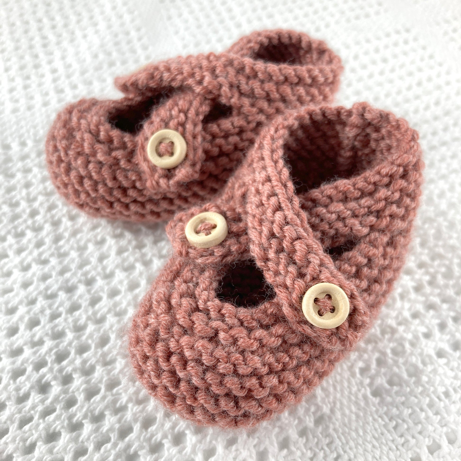 an easy knit pattern for baby shoes. sample knit in dusky rose coloured yarn