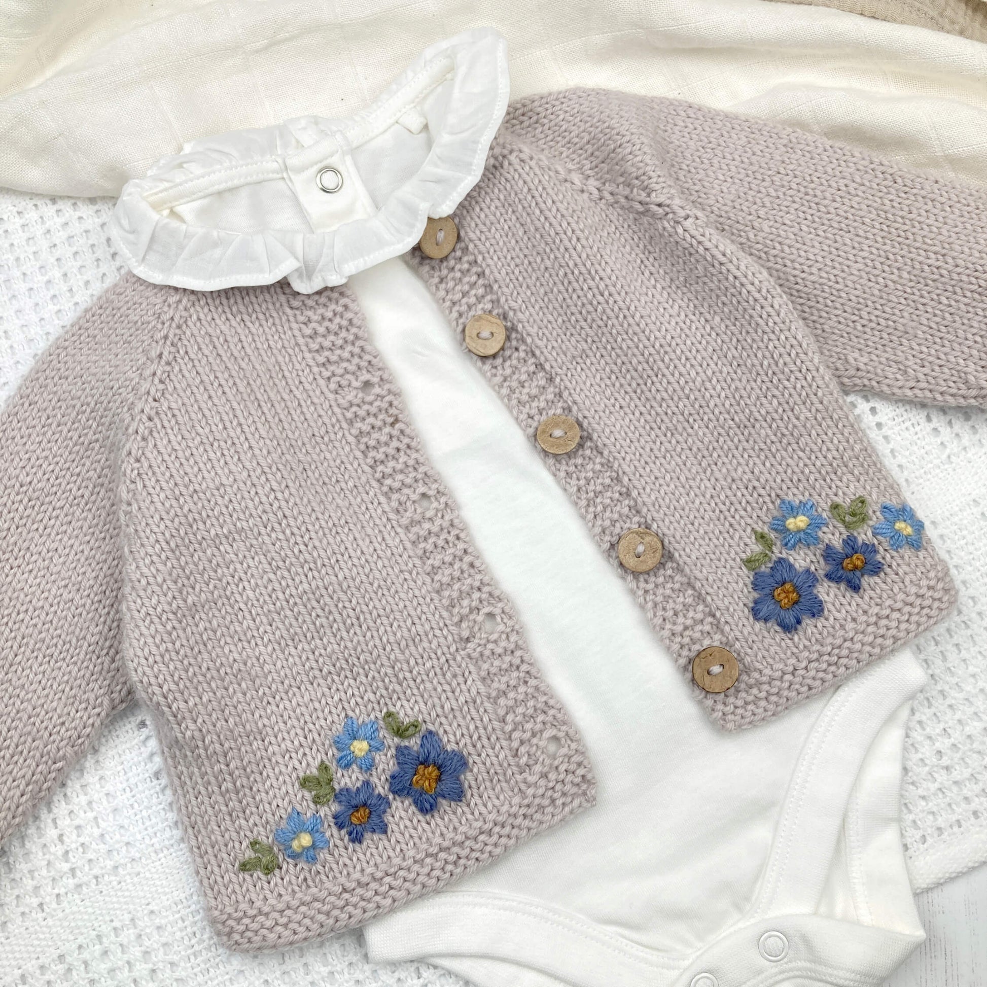  baby cardigan knitting pattern with floral patterns 