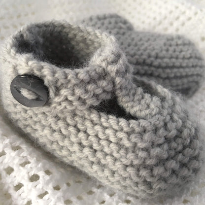 a knitting pattern for baby booties with buttons