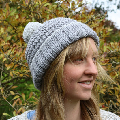 model is wearing a hat sample for a bobble hat knitting pattern