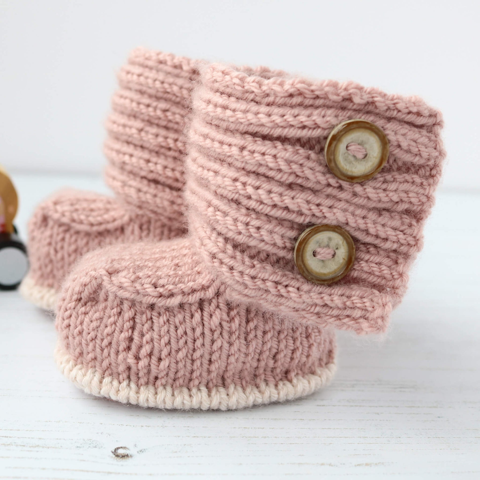 modern booties knit pattern shown in dusky pale pink