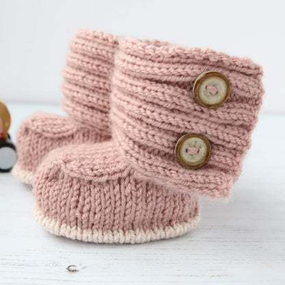 modern booties knit pattern shown in dusky pale pink